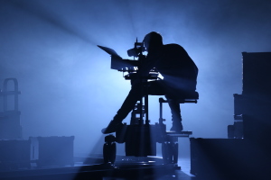 A camera set up on a jib with an operator close up